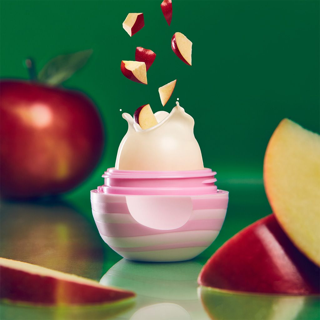 Photo illustration of open eos lip balm container showing apple flavor