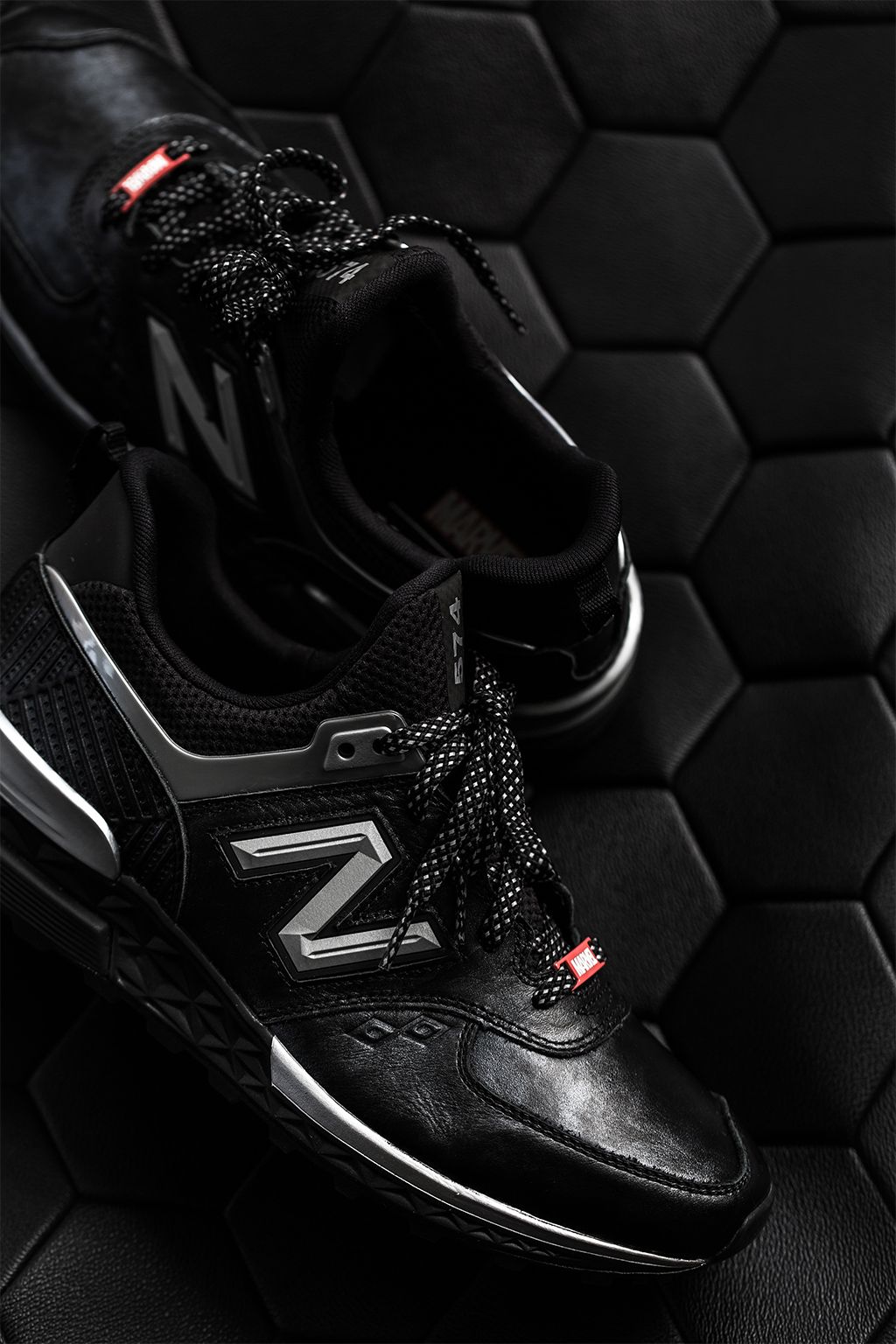 Detailed studio photograh of Black Panther New Balance shoes
