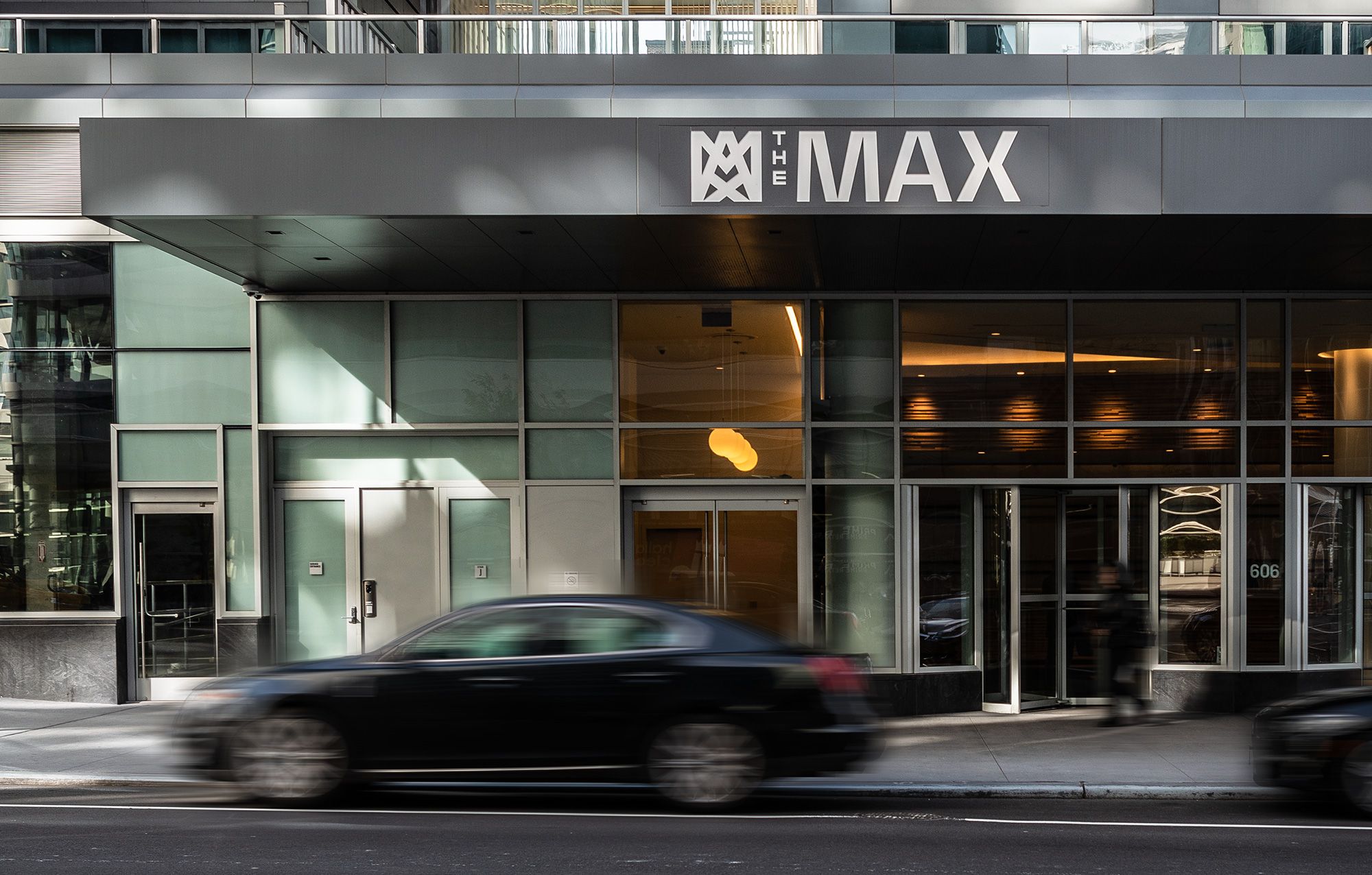 Photograph of The Max's entrance and canopy sign from street level during the day