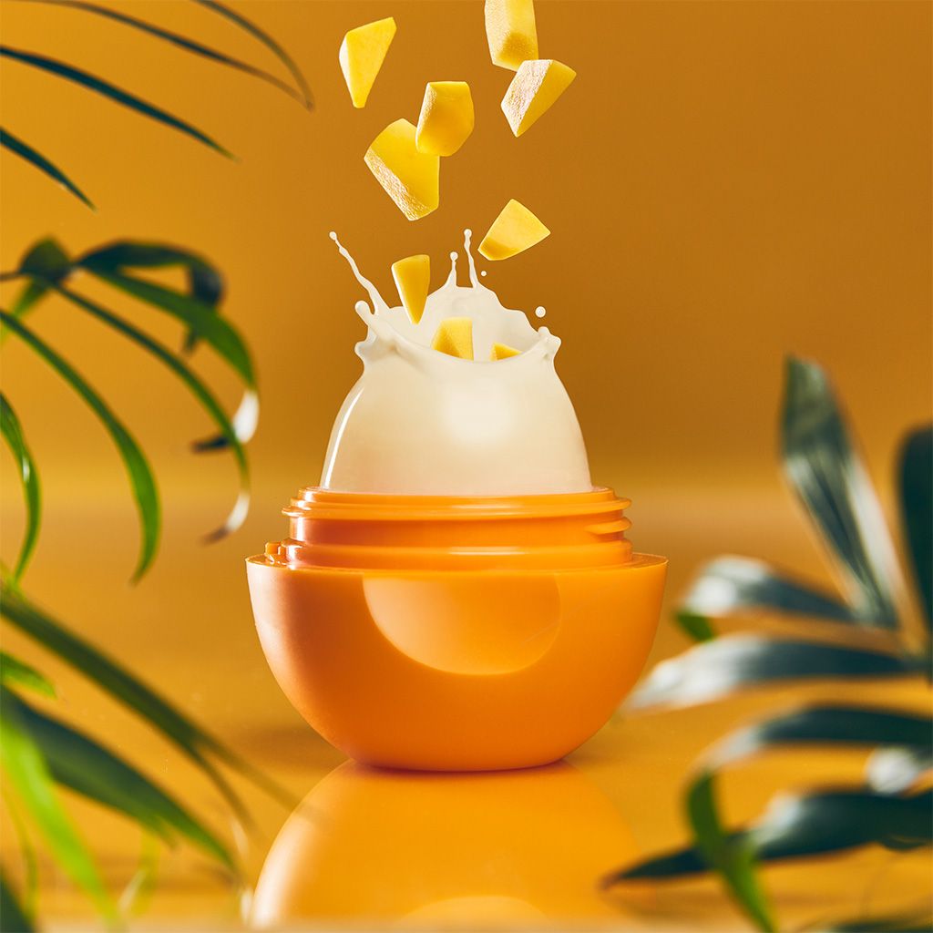Photo illustration of open eos lip balm container showing mango flavor