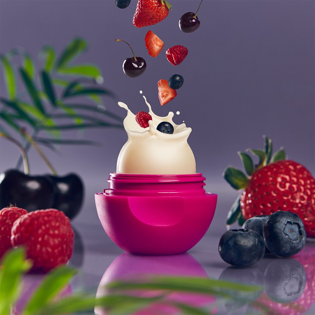 Photo illustration of open eos lip balm container showing berry flavor